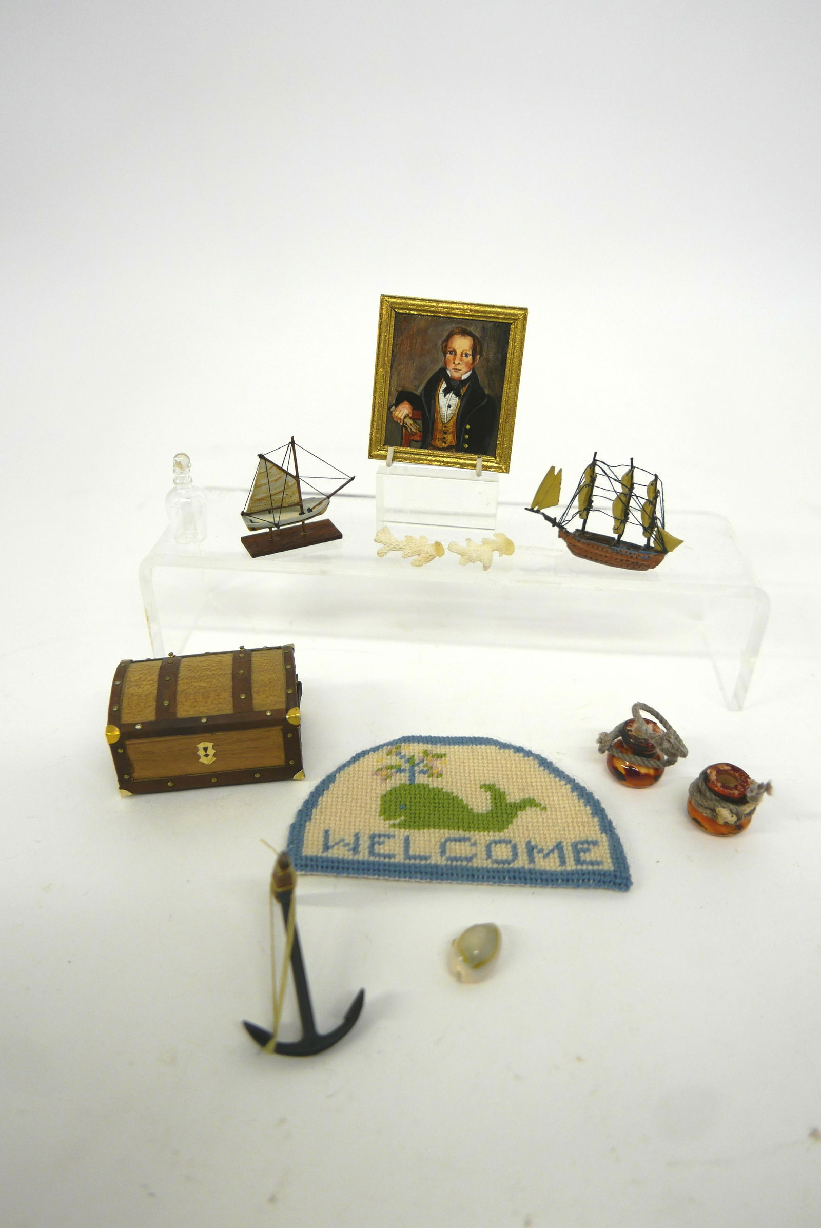 Amanda Skinner Portrait & Nautical Miniatures: Amanda Skinner original oil painting of a sea captain titled "Man With Gloves " mounted in a wood frame 1.75" by 2", also includes a metal ship model on wood base, all metal ship model 2"L, A. Lopez t