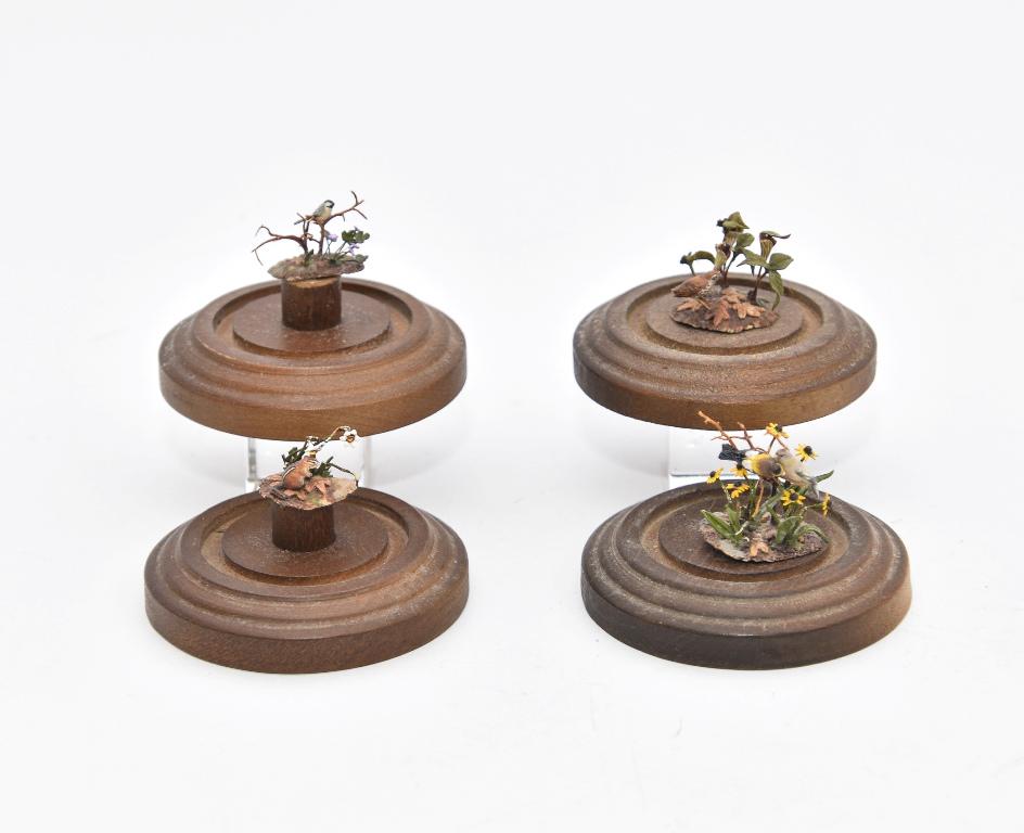 Four Mary McGrath Bird Sculpture Miniatures: Four small artisan bird dioramas by Mary McGrath under glass domes on wood bases 3.25"H, two are loose in domes and two are glued down, one dome has a loose bird