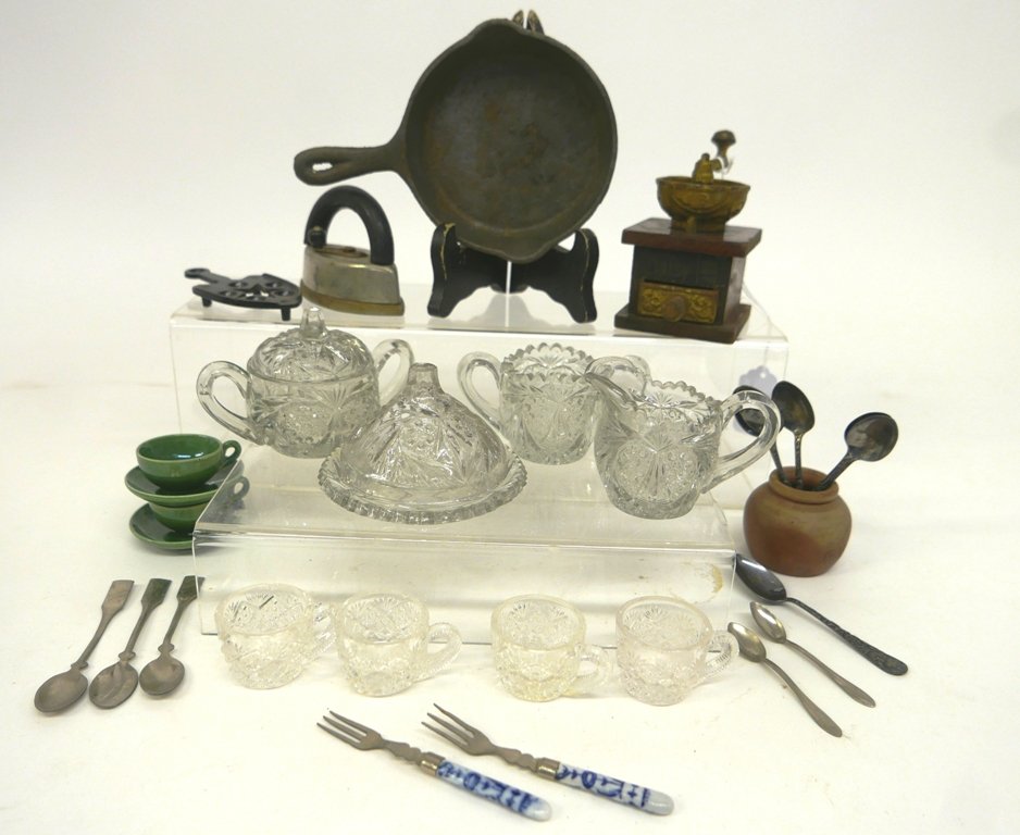 Vintage Doll Accessories Glassware, Coffee Grinder etc.: Vintage pressed glass doll covered cake plate 3.75"D, sugar, creamer, sugar bowl with lid, four teacups 1.25"H, child's toy sad iron and trivet, cast iron skillet 6.75"L, Daisy coffee grinder, stonewa