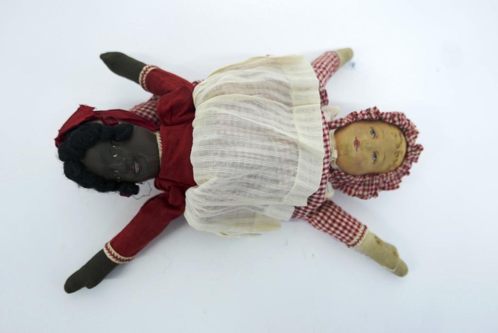 Bruckner Topsey Turvey Doll: 11" (28 cm.) An alternate doll head is posed on either side of a muslin torso ,and designed so that the full-length costume which accompanies each head will hide the alternate head. When the doll is f