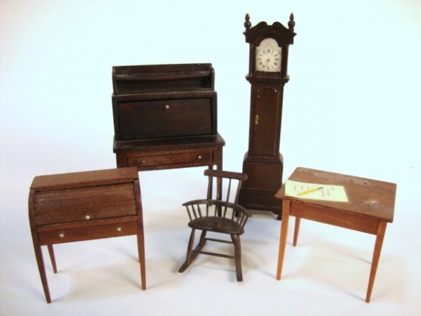 Assortment of Small Scale Artisan Furniture: An elegant tallcase clock 5" H with beautiful French polished finish, a drop-front desk 4" H, a smaller roll-top desk 2.25" H, a hand-carved Windsor rocker 2" H, and a signed Randy Himes table 2" H.