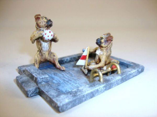 Vienna Bronze Pugs in Pool: Vienna Bronze pugs in pool, one with polka dot ball, the other in red and white lifesaver and small boat, great colors, blue appears like water. 1.25" H, 3" L.