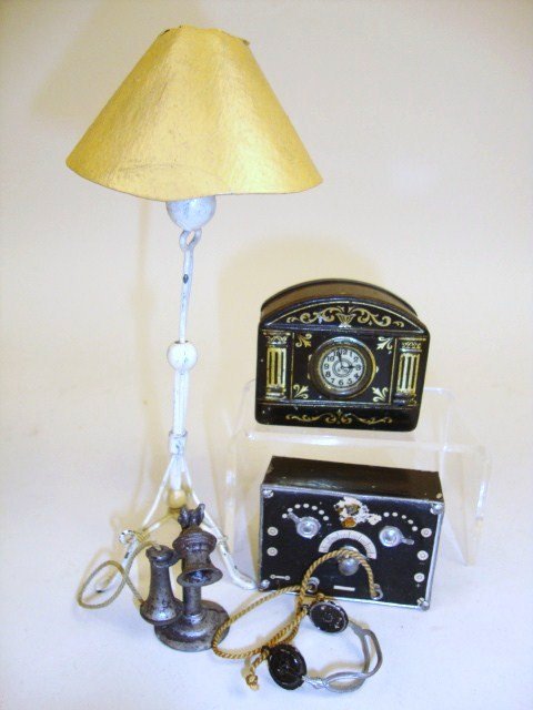 Assorted Painted Metal Accessories: A Westacre Village standing lamp 6" H, a crystal radio with headphones, a small tin pillbox clock marked Rountree on the back, and a candlestick telephone missing most of its paint.