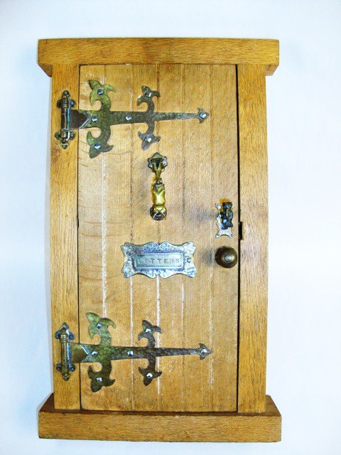 Salesman Sample Oak Door: Early 20th century oaken plank door 15" H featuring an abundance of cast and hammered brass hardware including hinges, knocker, working letter box, lock and key.
