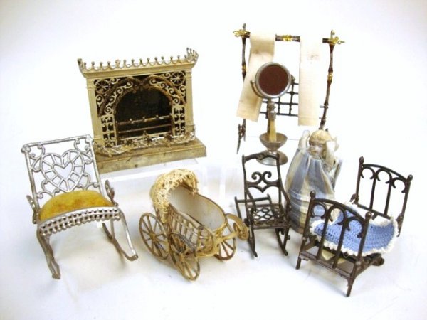 Soft Metal Furniture: Petite B. Schweizer painted fireplace 2.5" H, painted baby carriage, towel rack with asphaltum wash, Adrian Cooke rocking chair, French bed (with bisque bebe'), a metamorphic chair (missing front rock