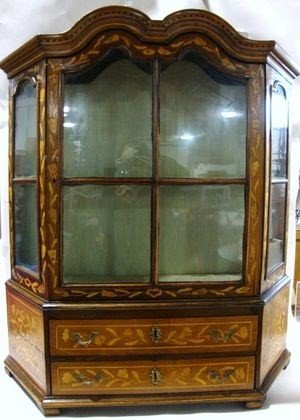 18th C. Dutch Marquetry Cabinet: An early padouk wood trapezoidal cabinet 40" H with marquetry tulips, double bonnet top pediment, two drawers with rococo ormolu pulls and escutcheons, glazed door and the interior lined with pale gre