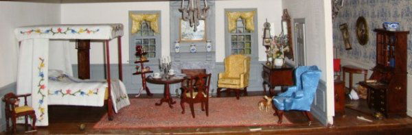 Grey Bedroom with Antechamber: A spacious bedroom with grey wainscot and trimwork, with a small antechamber to the right, commercial, kit and homemade furnishings, full tester bed with hand-embroidered hangings, dainty swags at bot