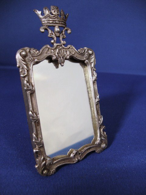 Meyers Vanity Mirror: Meyers vanity mirror, the frame with leaf scrolls at corners and leaf fronds spaced on side molding, shell centering base cap with a crown above, signed M & sterling on base 3.75" H.