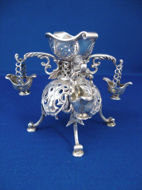 18th Century Georgian Style Epergne: 18th century Georgian style epergne on four high bracket feet with elaborately pierced central body skirt, rising into central basket with collar, with four compound scrolled arms from which are suspe