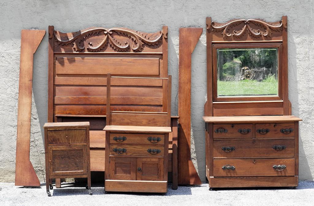 Victorian Oak Bedroom Set: Antique Victorian oak bedroom set has tall headboard with applied carved vines 57"W, 77"H with side rails and slats, bow front dresser with two half width drawers over two full width drawers 44"W, 21"