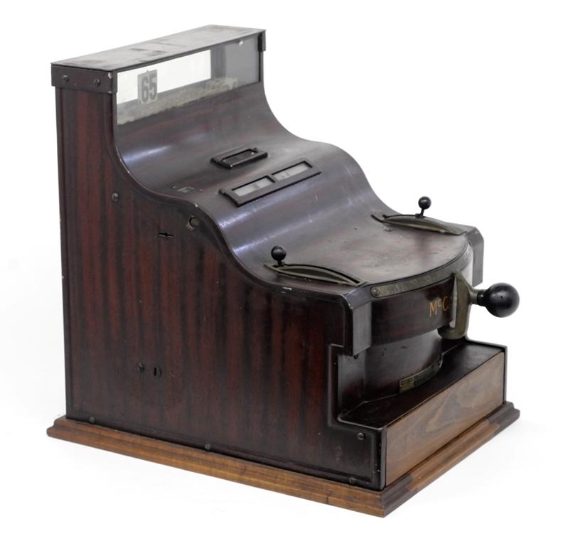 McCaskey Speed Cash Register: Vintage McCaskey Speed cheese cutter style cash register, wood grained metal exterior with wood base and drawer, three levers to adjust dollars, nickels and cents, 17"H, 13.25"W, 17"D