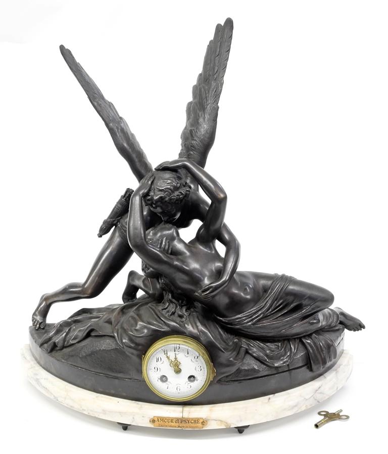 J.B. Hirsch Figural French Mantel Clock: Antique French figural mantel clock, spelter case with applied patina has a French foundry mark, eight day time and strike movement signed "J.B. Hirsch & Cie New York Made In France", porcelain dial s