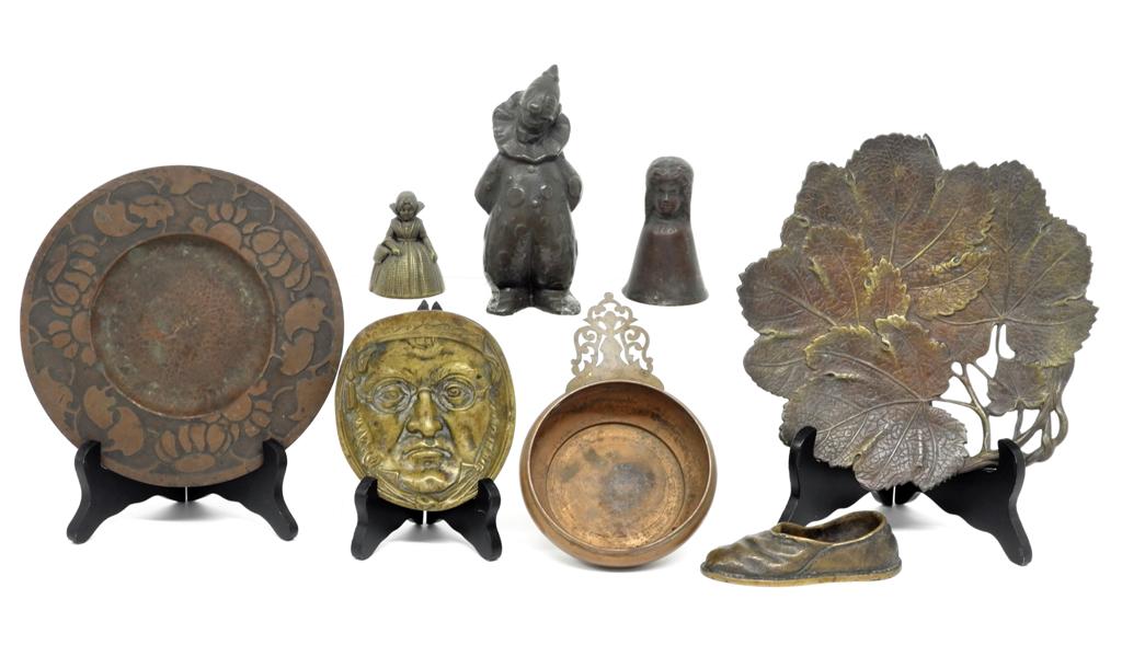 Assorted Antique Metal Collectibles: Brass leaf form tray 9"W, Art Nouveau copper round plate 8"D signed aqdoty, copper porringer, brass face dish on three feet, bronze two faced bell 3.75"H, Dutch brass figural bell, brass shoe ashtray,