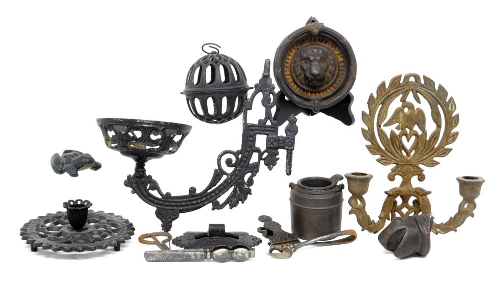Small Antique Iron Collectibles: Nice group of small antique iron items, lion head door knocker 4 5/8"D, frog, string holder, melted lead pot, clamp, Jew's harp, paper clamp, iron turtle head, nut cracker, double socket sconce
