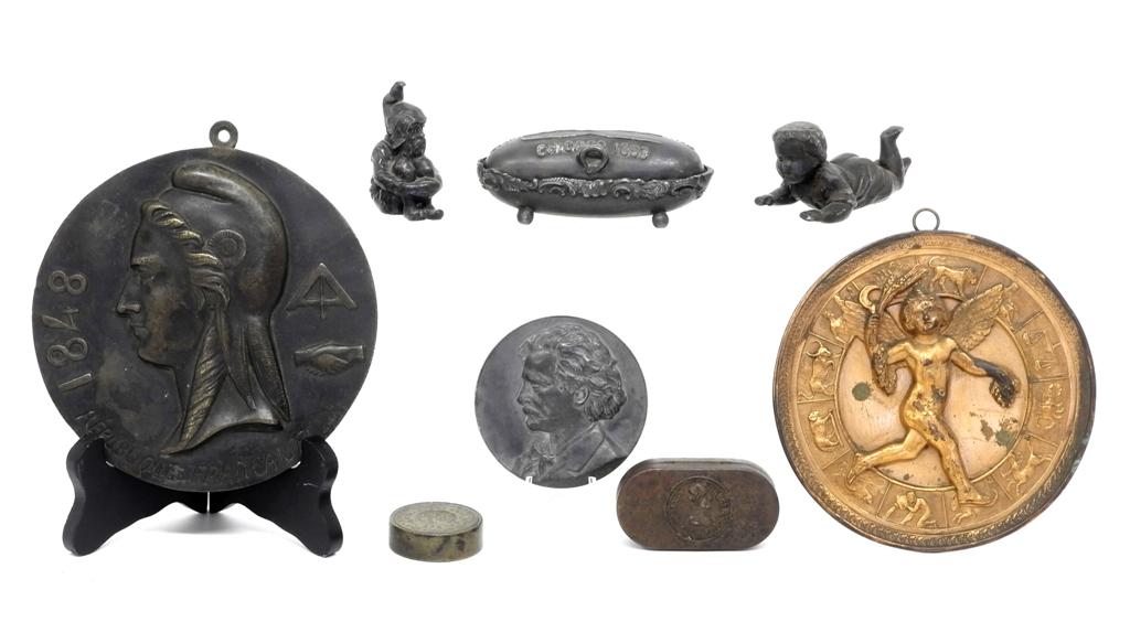 Small Antique Metal Collectibles: Metal trinket box advertising the World's Columbian Exposition Chicago 1893 4"L, French bronze plaque dated 1847 with fraternal symbols 6"D, Mark Twain desk medal 3"D, gilt tin angel plaque with zodia