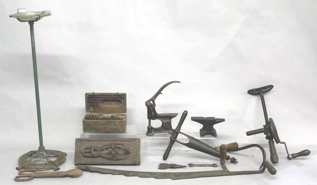 Group Of Antique Tools: Antique hay cutter 34"L, set of stamps in wood box, brace drill, small anvil 6.5"L, barrel bung hole drill, press, iron and wood shoe shine stand, bale hook, Ford model T wrench, metal snips, unusual