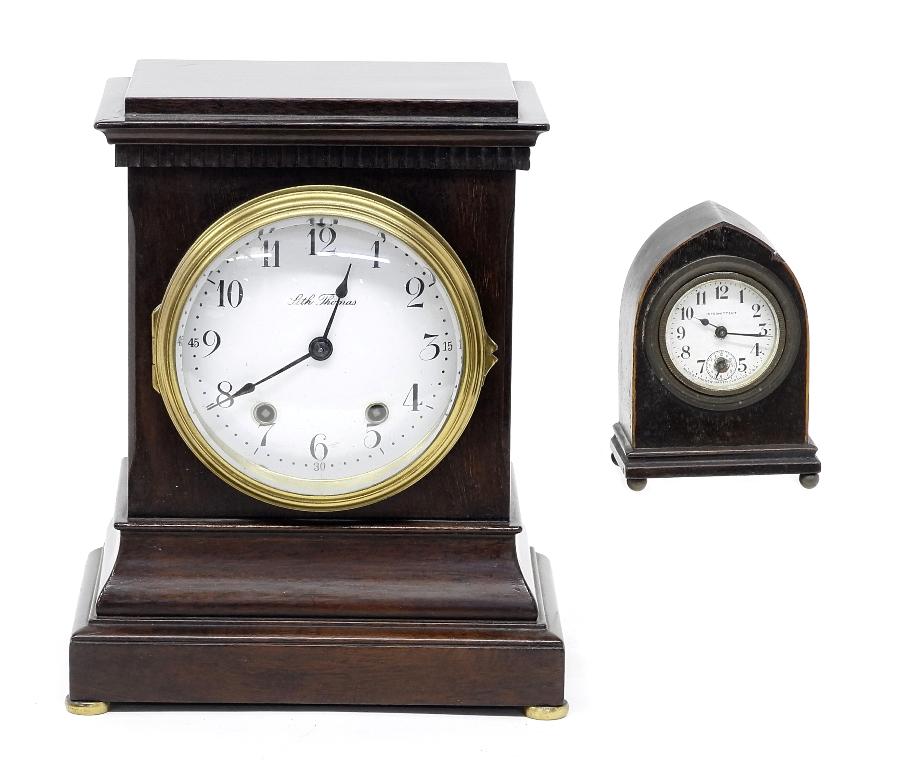 Two Antique American Clocks: Antique Seth Thomas mantel clock with good porcelain dial, quality eight day brass movement with time and strike comes with original pendulum and key 8.5"W, 10.5"H, Small New Haven alarm clock 4.5"H
