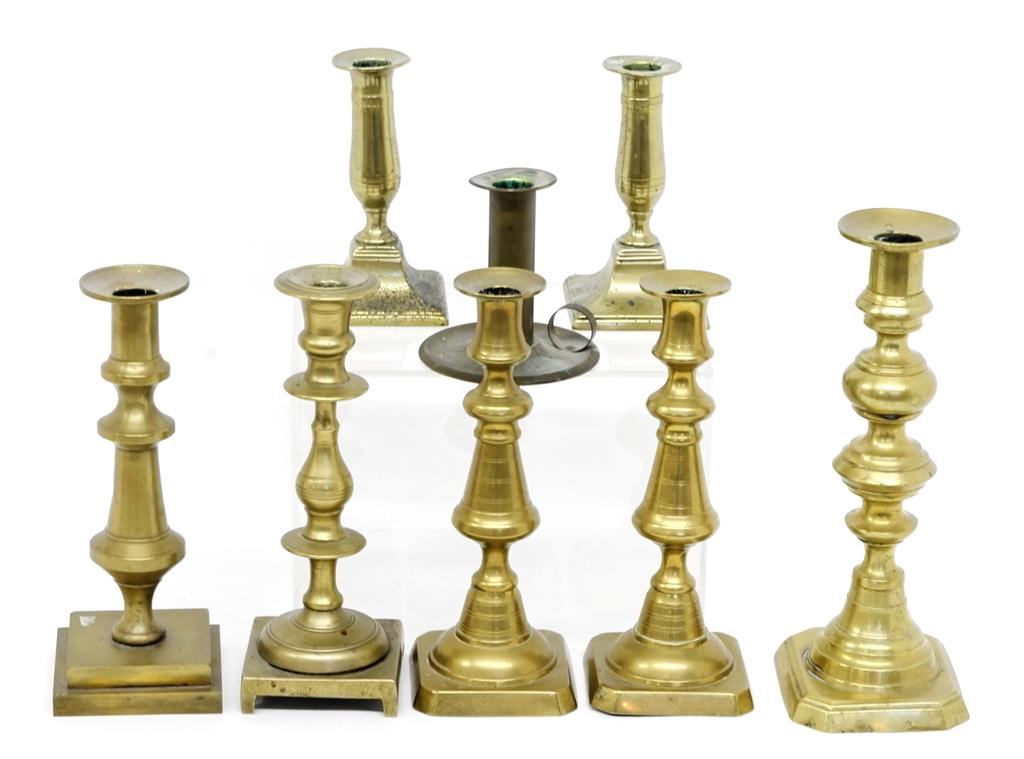 Group of Antique Brass Candlesticks: Pair of late Georgian short sticks 5.75"H missing push-ups, pair of beehive sticks 9"H, stick with solid very heavy base 8.75"H, two single sticks and a seamed chamber stick