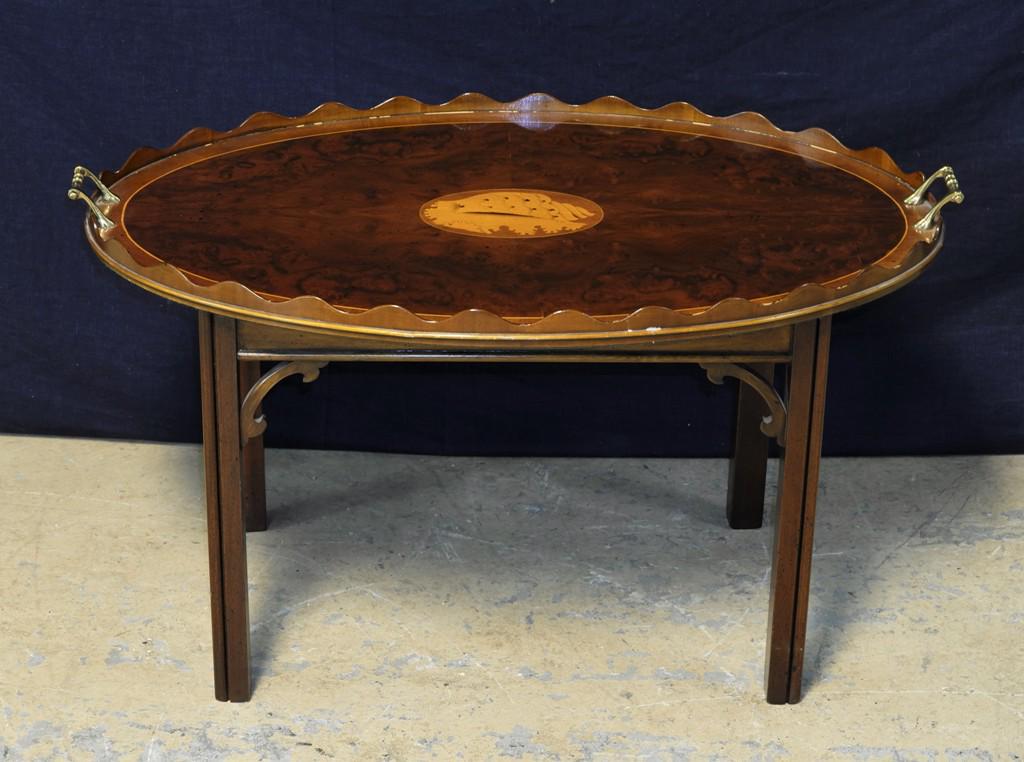 Inlaid Wood Serving Tray Coffee Table: Oval butler's tray, scalloped rim, veneer inlaid shell, brass handles 34"W, 22"D with a Chinese Chippendale style base, 19"H overall