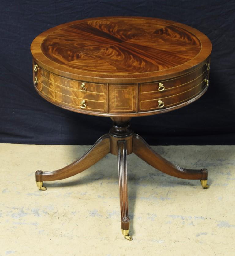 Inlaid Mahogany Drum Table: Nice quality contemporary reproduction mahogany drum table, top with mirror match veneer has satin wood stringing, body with single drawer and three faux drawers, cabriole legs with brass casters, 28"