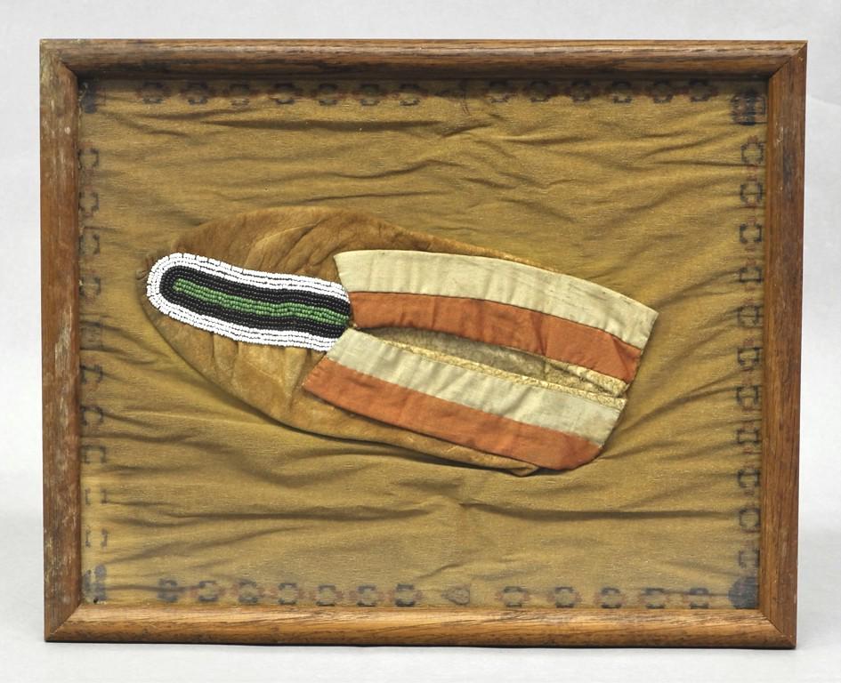 Antique Indian Moccasin: Antique Native-American leather moccasin with small trade beads and blanket material 10"L, housed in an old wood frame