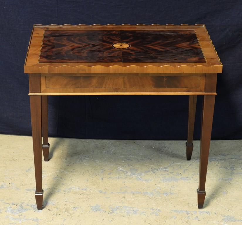 Hekman Hepplewhite Style Side Table: Mahogany side table with two pull out candle slides, scalloped top gallery, mirror matched veneer top with stringing and contrasting veneer, inlaid starbursts on top and legs, 28"W, 18"D, 25"H, buyer 