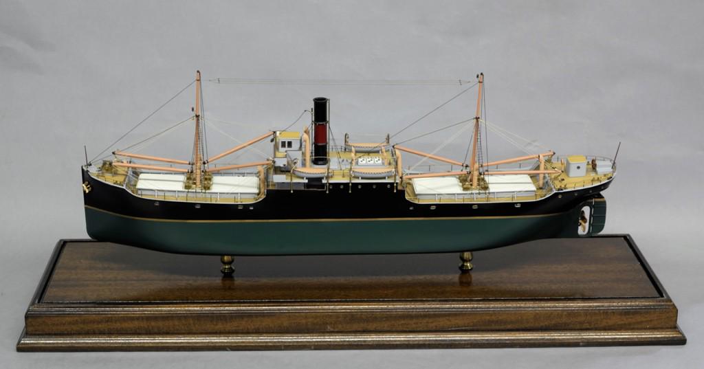 Cargo Ship Model In Case: Well detailed cargo ship model 32"L housed in a glass, brass and wood case 40"L, 12"D, 18"H, the ships is named Excalibur