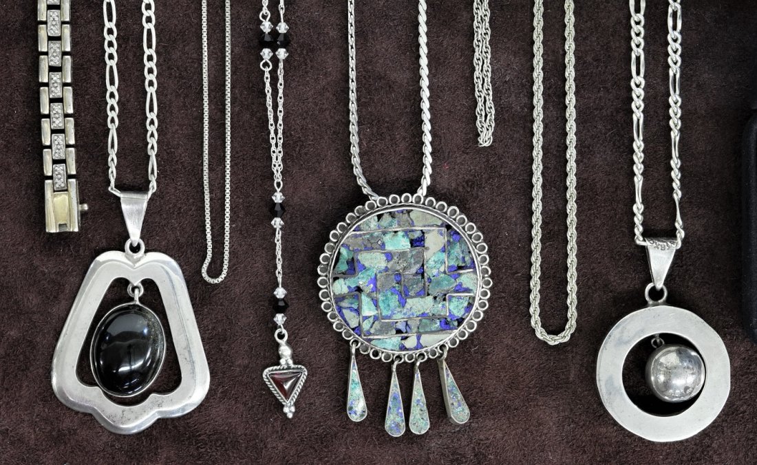 Collection of Sterling Silver: Three Mexican Pendants on Sterling Chains- Three Sterling Chains, One Necklace with Red Stones, Three Rings, One with Turquoise Stone, One with Multi Colored Stones. One with Marcasites, One Sterling 