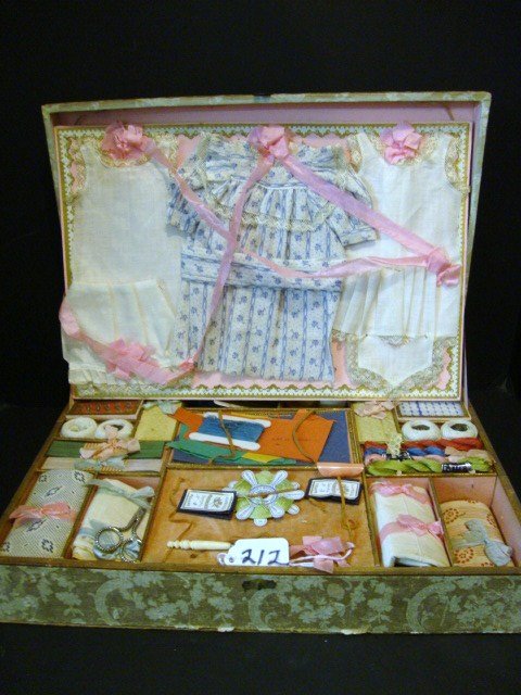 Lingerie Mi-Confectionnee` Doll Sewing Box: Lingerie Mi-Confectionnee` doll Sewing Box, Lid is colorful. This box contains, clothing on the top, and everything you need to fix a dress on the bottom, it retains its original ribbons that keep the