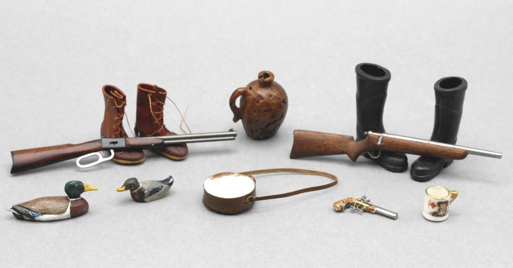 Hunting Accessories Dollhouse Miniatures: Includes a LJK hand carved and painted duck decoy 1 3/8"L, small MFC painted metal duck decoy, whiskey jug carved from a nut, flintlock pistol, bolt action rifle and lever action rifle, duck boots, ru