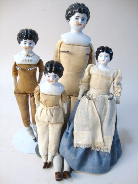 Lot of Four China Head Dolls: Lot of four china head dolls: 11 1/4" china head marked Germany, cloth body, bisque arms & legs, 7 1/2" china head Helen, white shirt w/gold trim original body, 6 5/8" china head marked 9 Germany prob