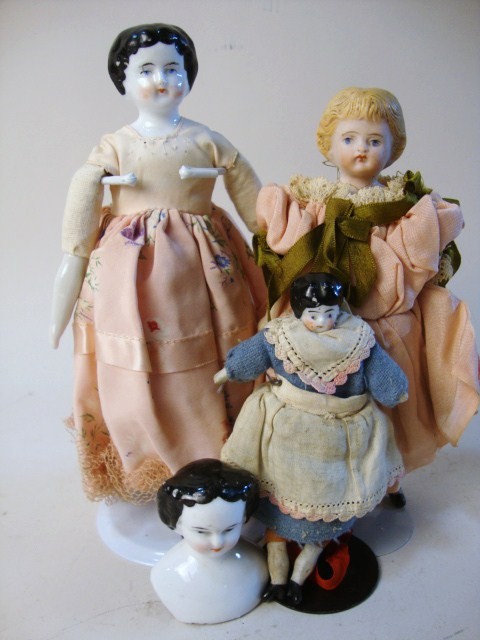 Group of China & Parian Dolls: Group of two china heads: 8 3/4" china head, arms & legs cloth body, 4 1/2" china head arms legs cloth body, 6 1/2" Parian head arms & legs cloth body 3 strap boots vintage clothing, 2" china head onl