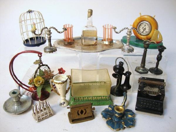 Grouping of Dollhouse Accessories: Beverage set, typewriter, telephone, candlesticks, fishbowl, birdcage, flowers, sailboat clock, toast rack marked sterling, toaster