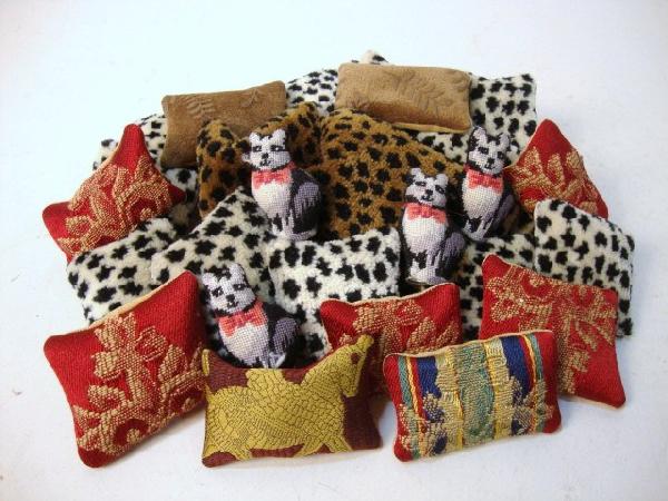 Designer Pillows: Large assortment of pillows, mostly by Pat Tyler, many in leopard print and brocade, filled with sand for a natural look. Also four needlepoint cat door-stops.