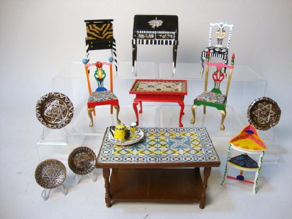 Eclectic Painted Furniture: Whimsical assortment of furniture painted in the style of MacKenzie-Childs, including two faux-tiled tables, three chairs, a desk, cellarette, washstand and a selection of painted platters.