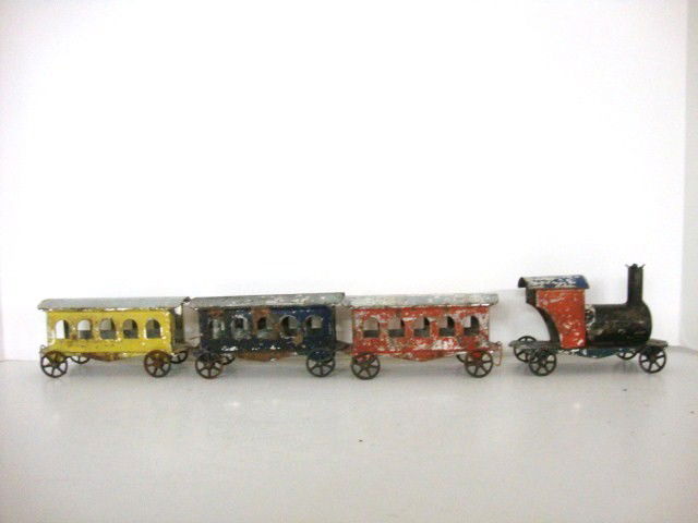 Vintage Antique 4 pc Tin Train Set: Antique probably late 19th century 4 piece painted Tin Train Set that includes the engine, and 3 passenger coaches. This is a very early piece probably Germany, but no markings anywhere. Paint has wea