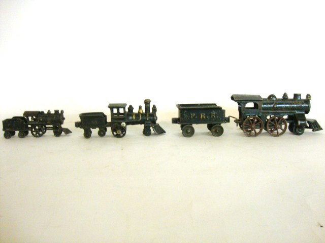 Cast Iron Train Lot 4 pcs: Four pieces of Cast Iron Trains, Engine w/PRR tender 12" total length, Engine #46 engine/tender combined 7" (l), Engine/tender combined PRR on tender 5 1/2" (l).