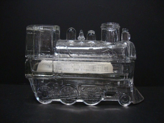 Glass Two Piece Train Candy Container: Glass Two Piece Train Candy Container, Dillon E. Mapother of Louisville, Ky, patented a locomotive candy container on December 20, 1892. See Illus. on page 391 in christian Revi's Book American Presse