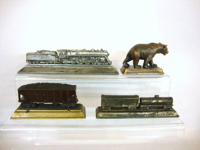 Desk Ornaments: Desk Ornaments , four pieces , Frame, Friend, & Stineman, Inc. Coal Car, Chicago, Milwaukee & St. Paul, Bear, Calvin Bullock Train, North American Car Company, all trains. 10" Longest