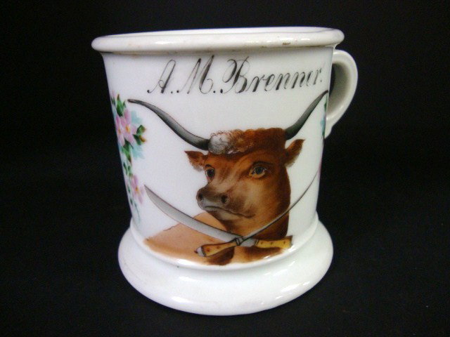 Occupational Shaving Mug: Mug signed by Koken St. Louis, Mo., butcher's mug shows hand painted steer w/crossed butcher knife & sharpener, surrounded on backsides by flowers, 4" (t)