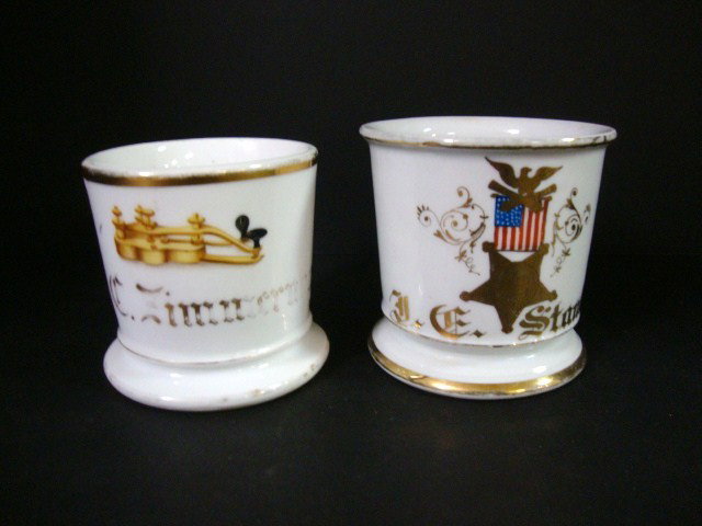 Two Occupational Shaving Mug: Mug depicts 5 sided star logo of the GAR surmounted by American flag topped by spread wing eagle & crossed cannons, 3 3/4 "(t), other depicts telegraph key, 3 1/4" (t)