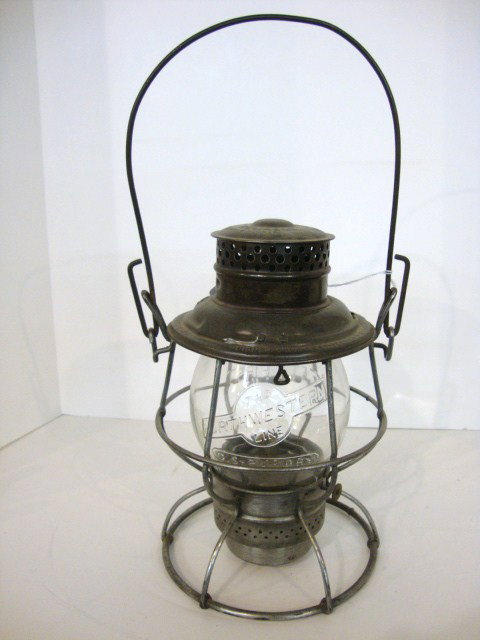 Wire Ring Bottom Railroad Lantern: C.St P M & O RR, Adams & Westlake on lid, clear 5 1/2" globe, Northwestern logo embossed on globe w/C St P M & O R beneath embossed also,and Safety First embossed on rear of globe, twist off base