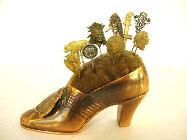 Indian Stick Pin: Nine Vintage Indian Stick Pins, etc. in brass pin cushion shoe, some buffalo & bear, 5" x 5", sterling & brass