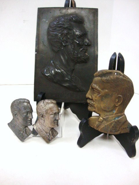 Presidential Memorabilia: Two Paperweight busts of FDR with "A New Deal" written imprinted along the collar, one hanging bust of Teddy Roosevelt with "Square Deal 1904" imprinted on his collar and shoulder and a German tin, co