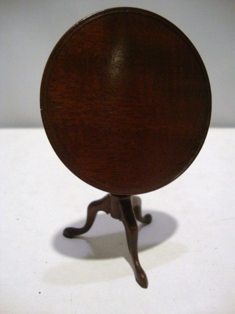 Eric Pearson Tilt-top Table: Mahogany tilt-top table with raised rim and pad feet 2.5" H.