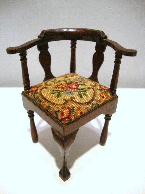 Eric Pearson Corner Chair: Classic mahogany corner chair with claw and ball foot and upholstered with antique petitpoint. 2.75" H. End of one arm repaired.