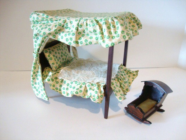 Tynietoy Canopy Bed and Cradle: Classic Tynietoy canopy bed with printed cotton upholstery 6.5" L, 7.5" H and a cradle with mattress, both marked Tynietoy but ordered from Chestnut Hill in the early 1950's.
