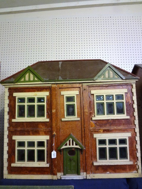 Vintage English Stockbroker Tudor Dollhouse: A large English dollhouse with attractive painted half-timbered and brickpaper exterior, hinged front panels (hinges damaged or missing), interior comprising four spacious rooms and center hallway wit