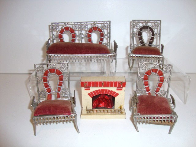 Peter Pia Fairy Furniture: Set of antique Peter Pia soft metal furniture including a settee 4.5" L, rocker and two armchairs and a small German painted tin fireplace.