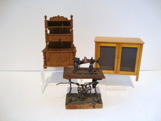 Antique Miniature Sewing Machine: An old sewing machine on stand 4" H, probably Mexican, along with a German cabinet 4.75" H (missing one drawer) and a modern pie safe.